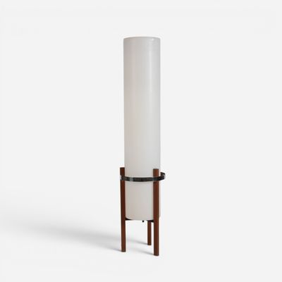 a tall white cylinder lamp with wooden legs and a white cylinder shade