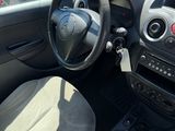 the interior of a small car with a steering wheel and dashboard