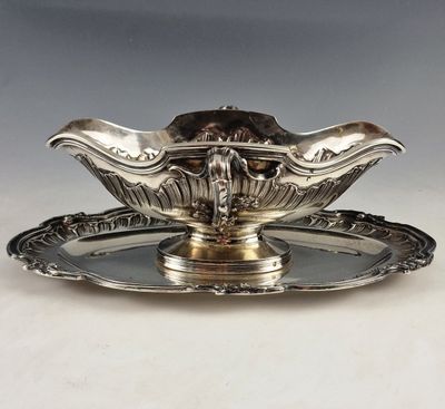 a silver plate with a bowl on top of it