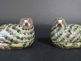 two green and yellow birds sitting on top of each other