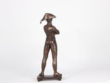 bronze statue of a man with a hat on his head holding a baseball bat