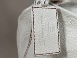 a close up of a white purse with a tag on it