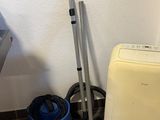 a washing machine and a vacuum in the corner of a room