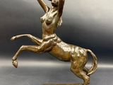 an image of a bronze statue of a woman on a horse