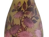 purple and yellow vase with flowers on it on a white background