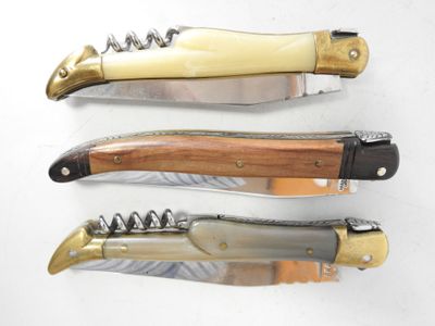 three different types of knifes on a white surface