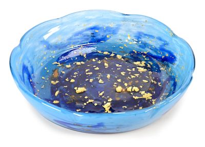 a blue bowl with gold flakes in it