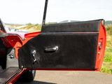 a red and black car with its door open