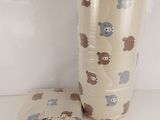 a teddy bear pattern on the wall next to a pillow
