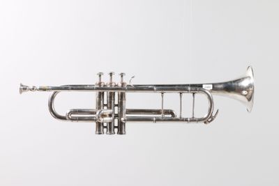 a close up of a silver trumpet on a white background