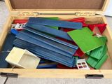 a wooden box filled with assorted pieces of construction material