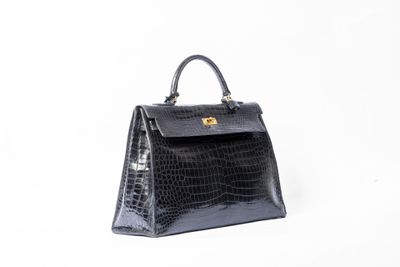 un sac à main en cuir de crocodile noir sur fond blanc