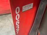 a close up of a red door with a sticker on it