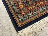 a rug on the floor with a cat sitting on it
