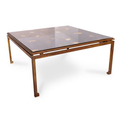 une photo d'une table basse avec un plateau en verre et des pieds en métal