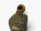 a blue and gold vase with a picture on it