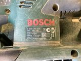 a close up of a bosch drill on a table