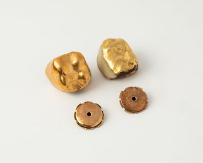 two gold nuggies and two small nuggies on a white surface