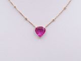 a gold necklace with a heart shaped pink stone on it