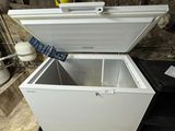 a white chest freezer sitting in a garage
