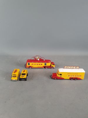 two toy trucks and a fire truck on a table