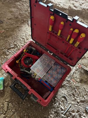 a red case with tools in it sitting on the ground