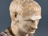 marble bust of a man in a plaid shirt with his head turned to the side
