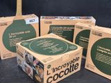 three boxes of chocolate sitting on top of a table next to each other