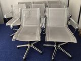several chairs are lined up in a row on a blue carpet