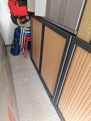 a luggage bag sitting on top of a cabinet in a room