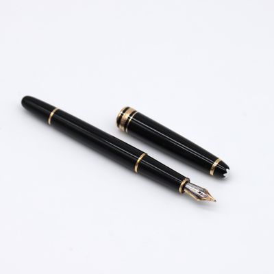 two black and gold fountain pens sitting on top of a white surface