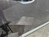a reflection of a person walking on the street