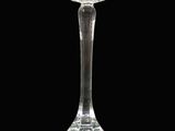 a clear glass candle holder on a black background