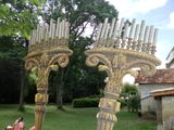 two menorah candles that are on a stand in the grass