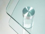 a glass table with a metal knob on top of it
