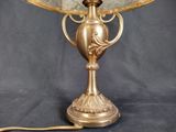 a lamp that is sitting on a table next to a lamp shade