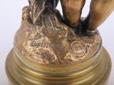 a statue of a woman holding a bird on a pedestal