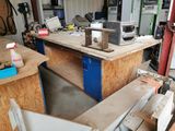 a picture of a workbench in a garage with a lot of clutter