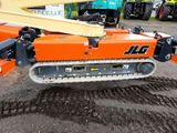 a large orange machine that is sitting in the dirt