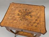 a small wooden table with a decorative design on it