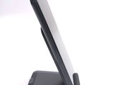 a cell phone on a stand on a white surface