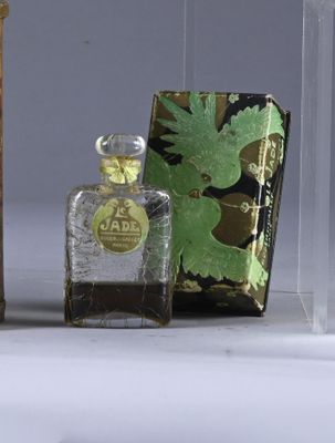 three bottles of perfume sitting next to each other on a table