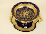 a blue and gold plate with a gold flower design on it