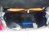 a trunk of a car with a surfboard in it