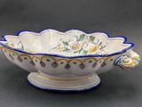 a white bowl with blue and yellow designs on it