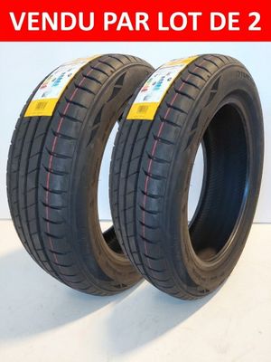 a pair of two tires on a white surface with a red stripe