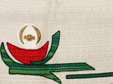 embroidery design of a red flower with a green stem on a white cloth
