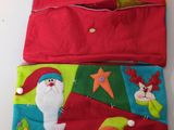 two red and green christmas pouchs with santa and snowmen on them