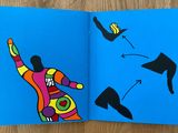 an open book with a drawing of a person throwing a frisbee