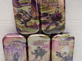 four tins of pokemon tins are stacked on top of each other